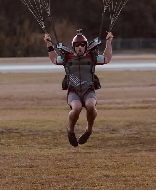 Miles Garner landing under a parachute canopy