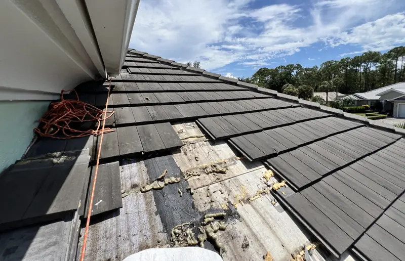 Roof repair in progress (before/during photo) by Epoch Roofing in Naples, FL